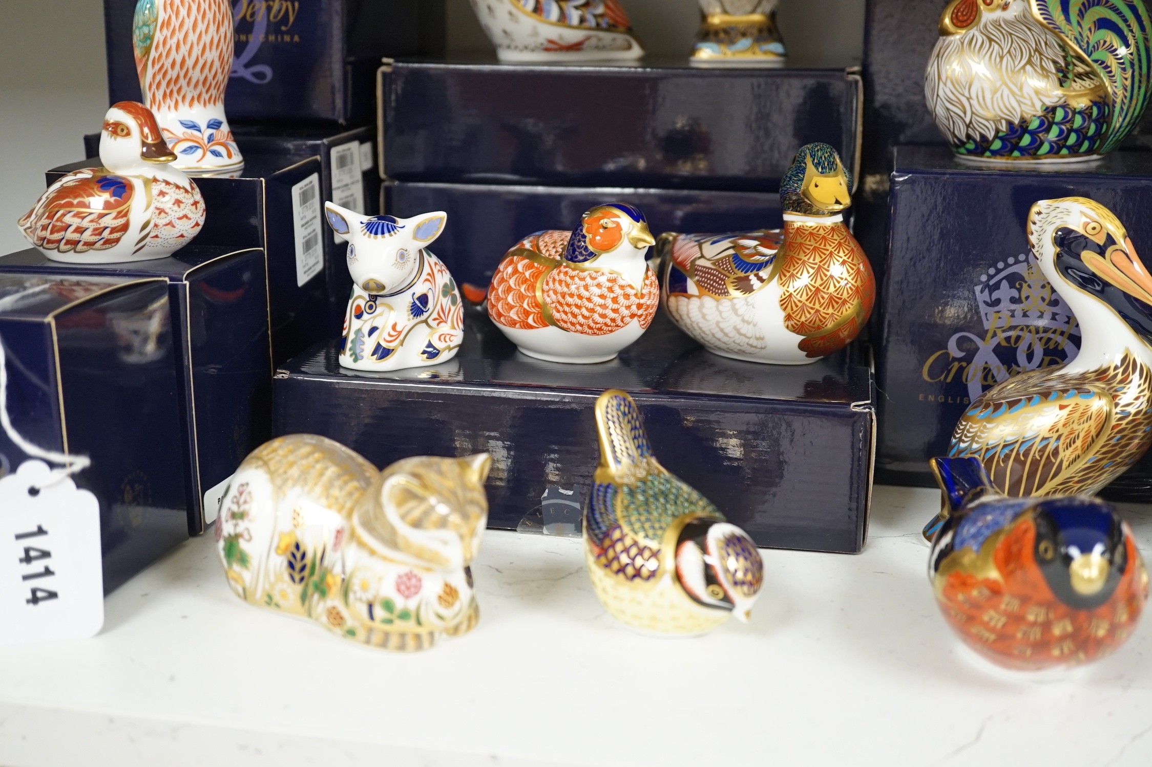Approximately thirty-two Royal Crown Derby Imari porcelain paperweights, all but two with original boxes and mostly gold bottoms